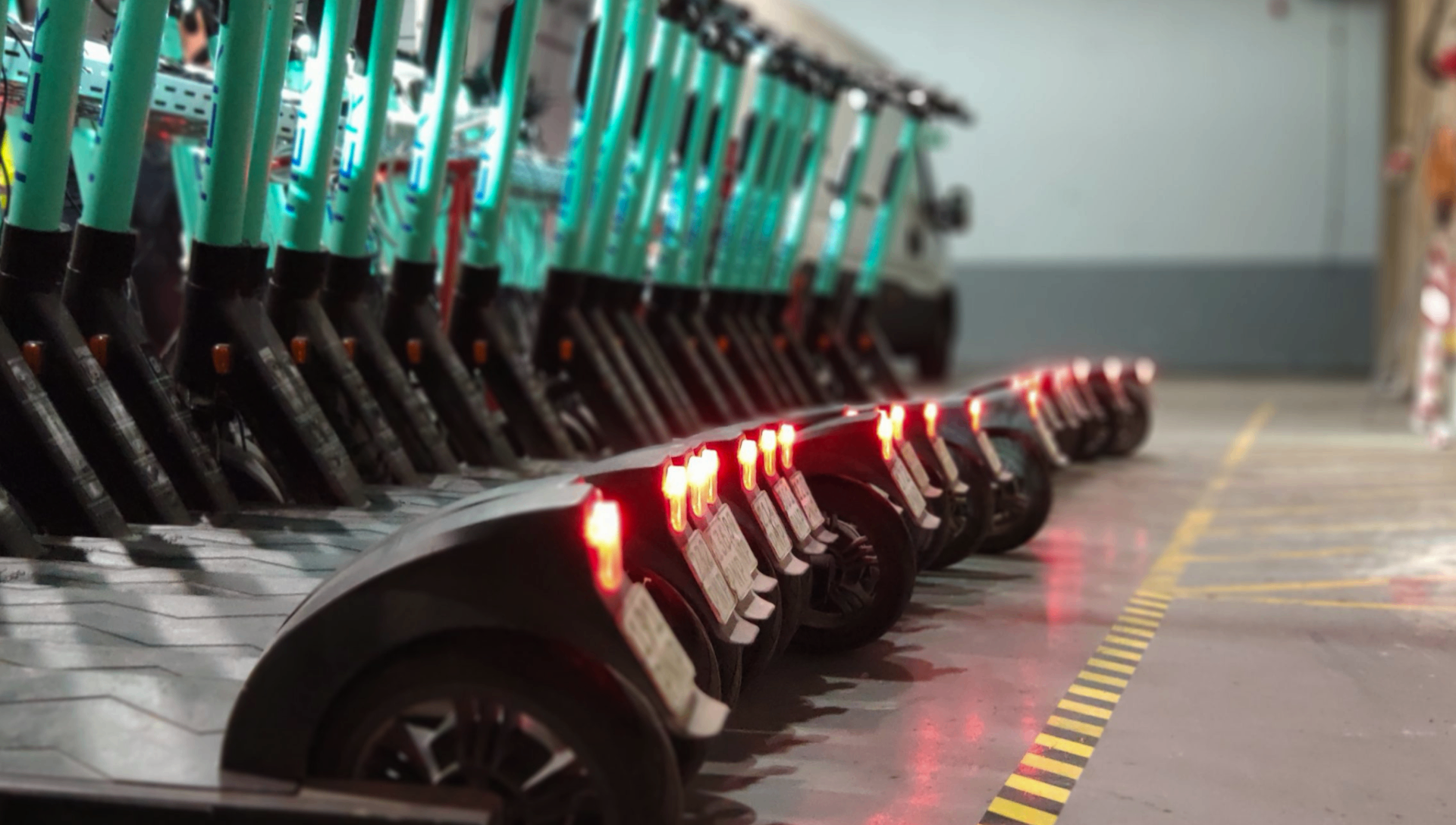TIER scooters lined up in warehouse